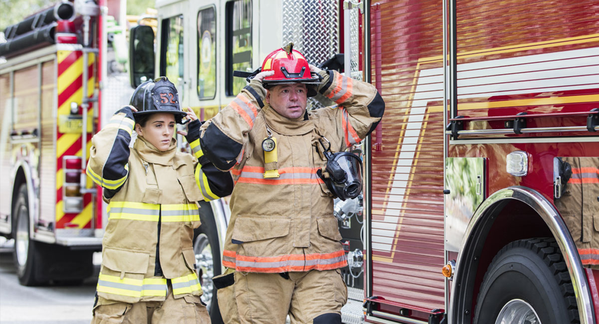 firefighters walking beside fire truck